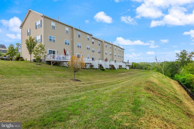 a view of a patio with table and chairs and potted plants