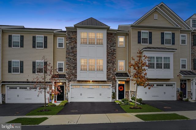 a front view of a residential apartment building with a yard