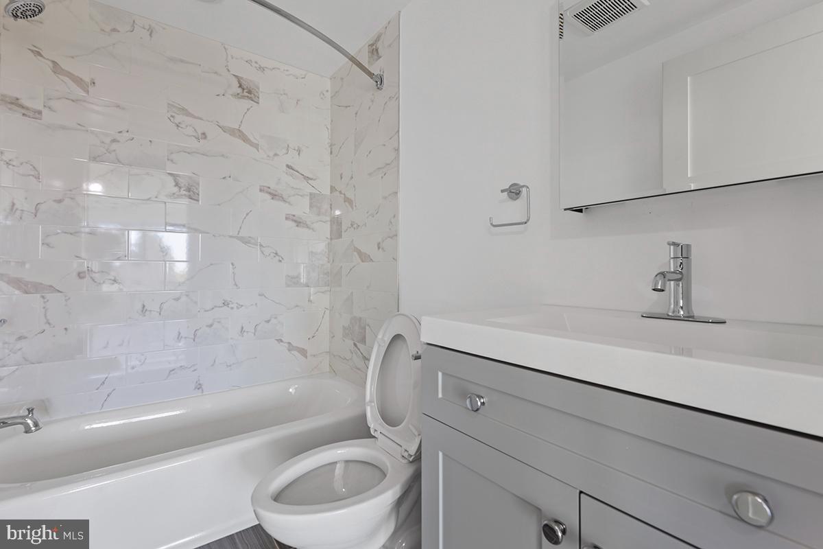 404 Fountain Street, Unit 307 Philadelphia, PA 19128 - Photo 13 of 15 a bathroom with a sink a toilet and bathtub