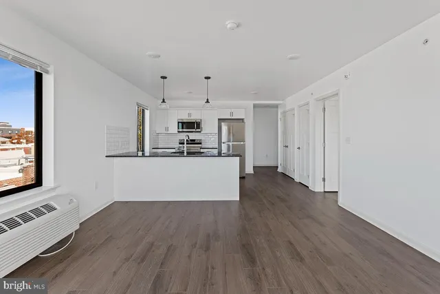 a kitchen with stainless steel appliances a refrigerator and a stove top oven