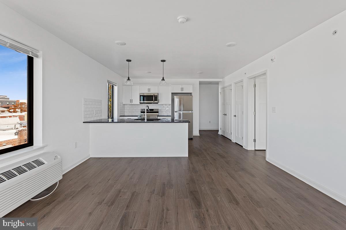 404 Fountain Street, Unit 307 Philadelphia, PA 19128 - Photo 3 of 15 a kitchen with stainless steel appliances a refrigerator and a stove top oven