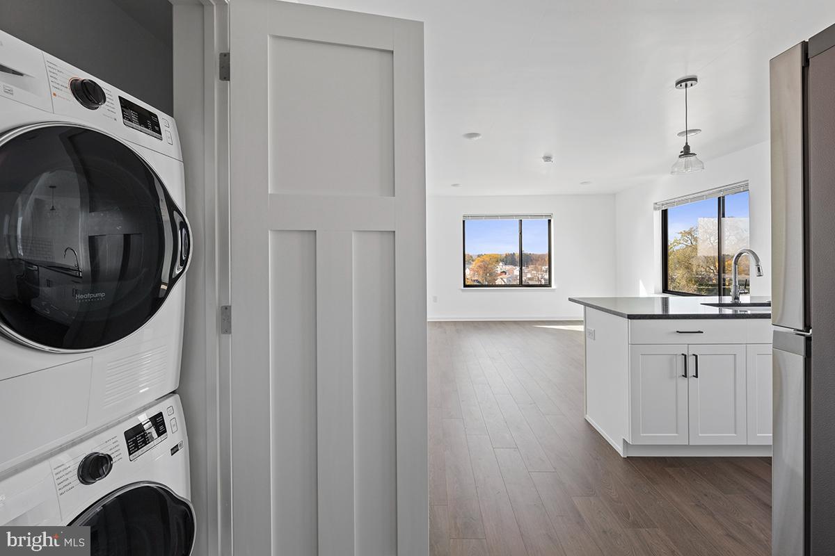 404 Fountain Street, Unit 307 Philadelphia, PA 19128 - Photo 4 of 15 a view of a kitchen with washer and dryer