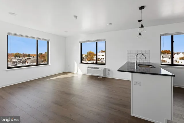 a room with wooden floor and window
