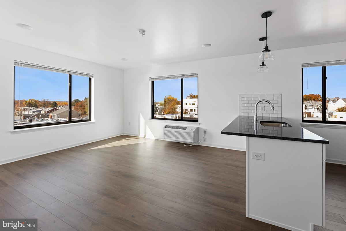 404 Fountain Street, Unit 307 Philadelphia, PA 19128 - Photo 5 of 15 a room with wooden floor and window