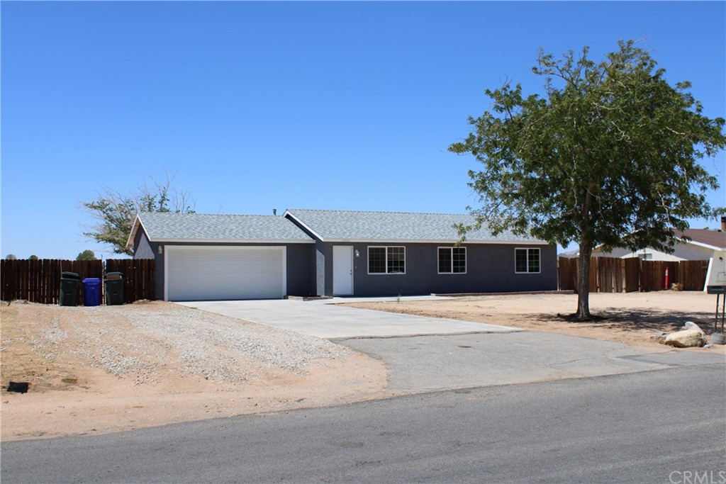 15124 Quinnault Road Apple Valley, CA 92307 - Photo 1 of 1 a front view of a house with a yard