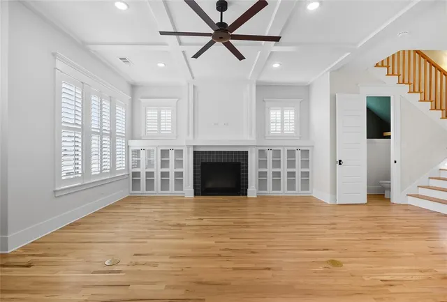 a view of an empty room with a fireplace and a window
