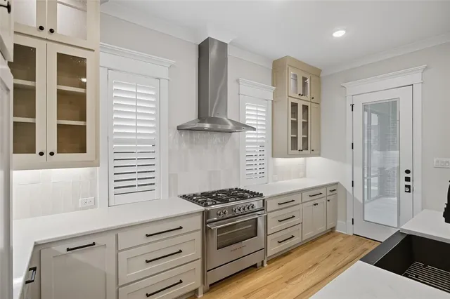 a kitchen with stainless steel appliances granite countertop a stove and a sink