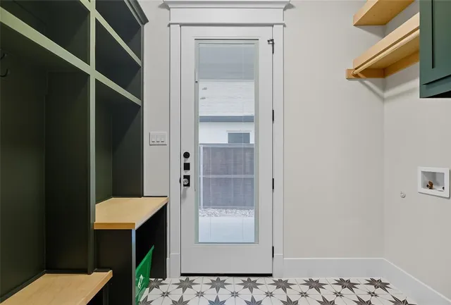 a view of a hallway with wooden floor and cabinet