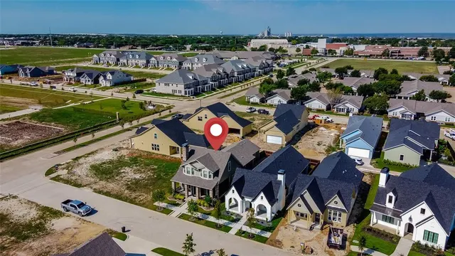 an aerial view of a house with a garden and lake view
