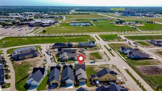 an aerial view of a house with a garden potted plants and large trees