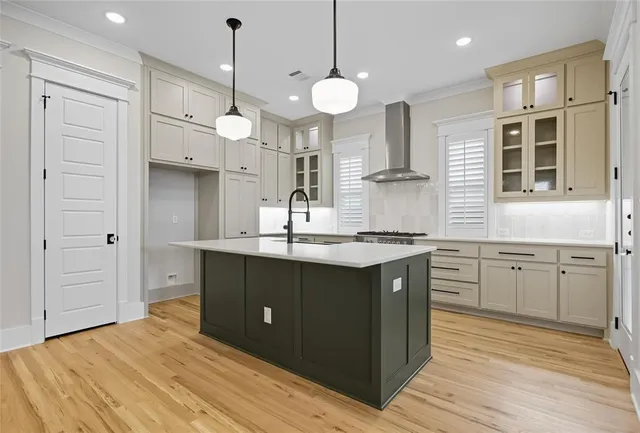 a kitchen with stainless steel appliances granite countertop a sink a stove and a refrigerator