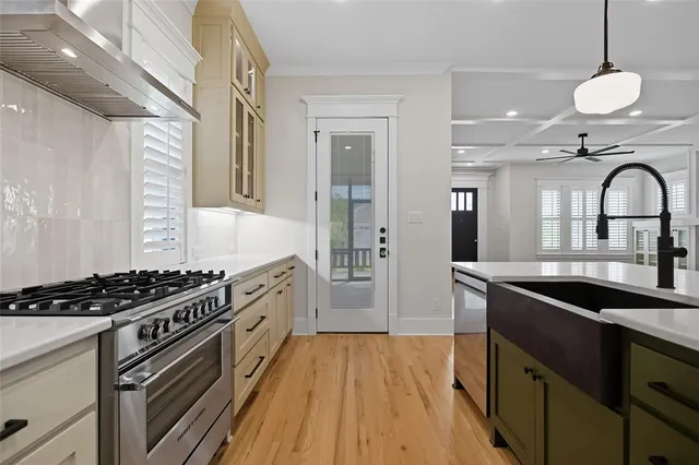 a kitchen with granite countertop a sink stove and cabinets