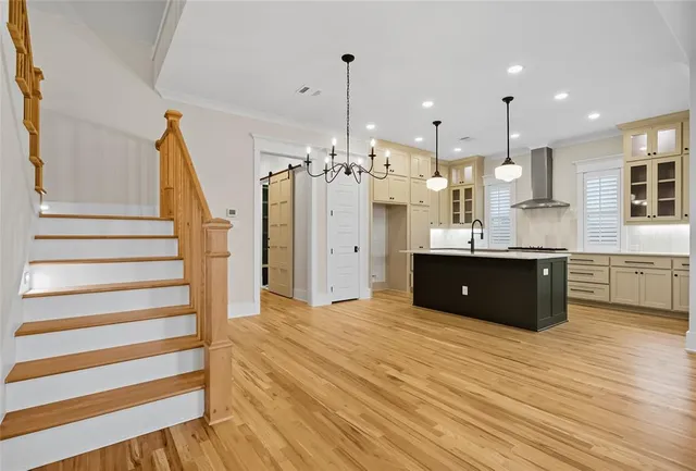 a view of kitchen and hall with wooden floor