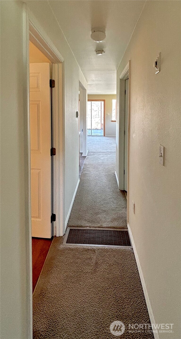 20548 Northeast 22nd Road Marlin, WA 98832 - Photo 9 of 26 a view of a hallway with wooden floor and staircase