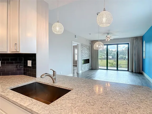a kitchen with a sink cabinets and wooden floor