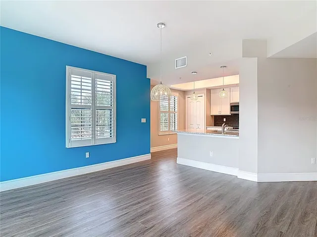 a view of a balcony with a floor to ceiling window and wooden fence