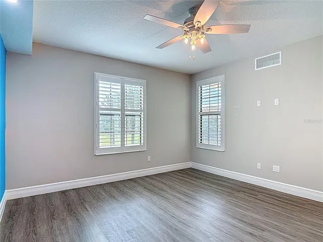 a room with walk in closet and wooden floor