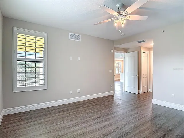 a bathroom with a granite countertop sink mirror and shower