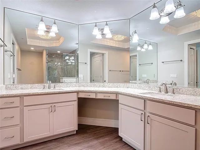 a bathroom with a double vanity sink a toilet and a mirror