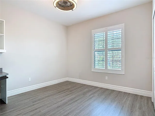 an empty room with wooden floor and closet