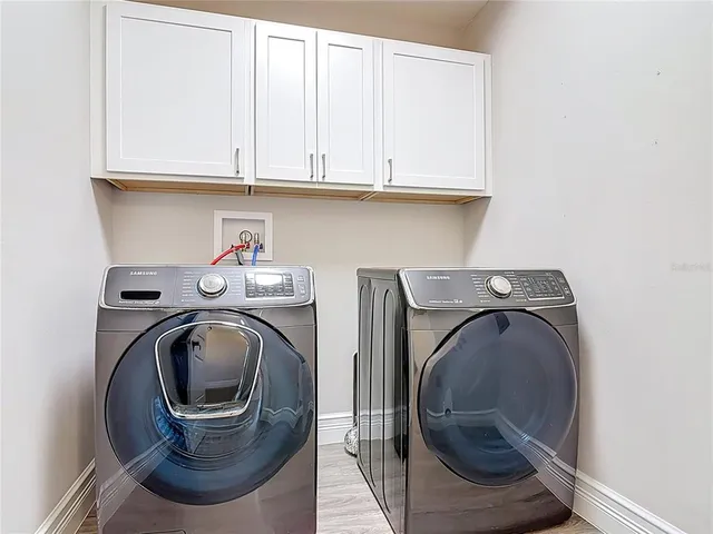 an aerial view of residential houses with outdoor space and river