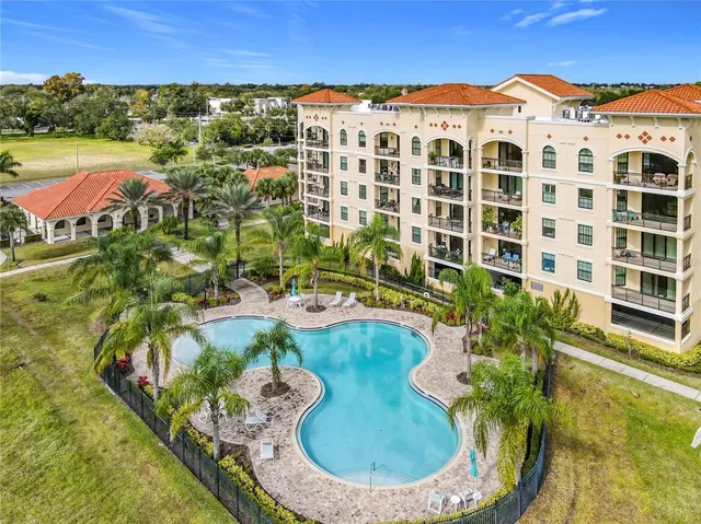 an aerial view of residential house with outdoor space and swimming pool