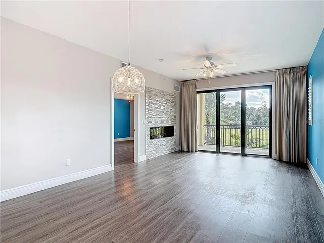 a view of a kitchen with granite countertop stainless steel appliances and wooden floor