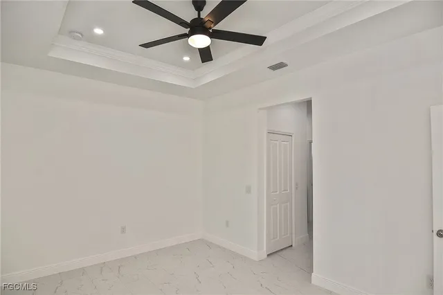 an empty room with a ceiling fan and a fan