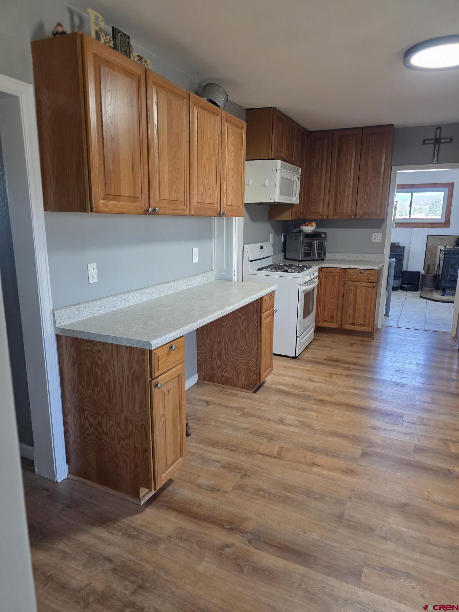 62500 Lasalle Road Montrose, CO 81403 - Photo 13 of 15 a kitchen with wooden floors and wooden cabinets