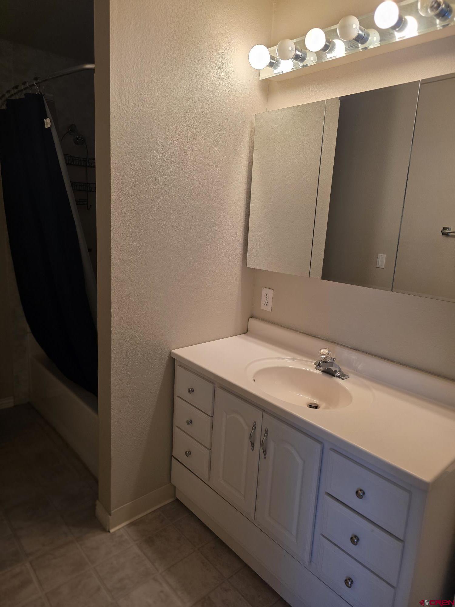 62500 Lasalle Road Montrose, CO 81403 - Photo 14 of 15 a bathroom with a double vanity sink and mirror
