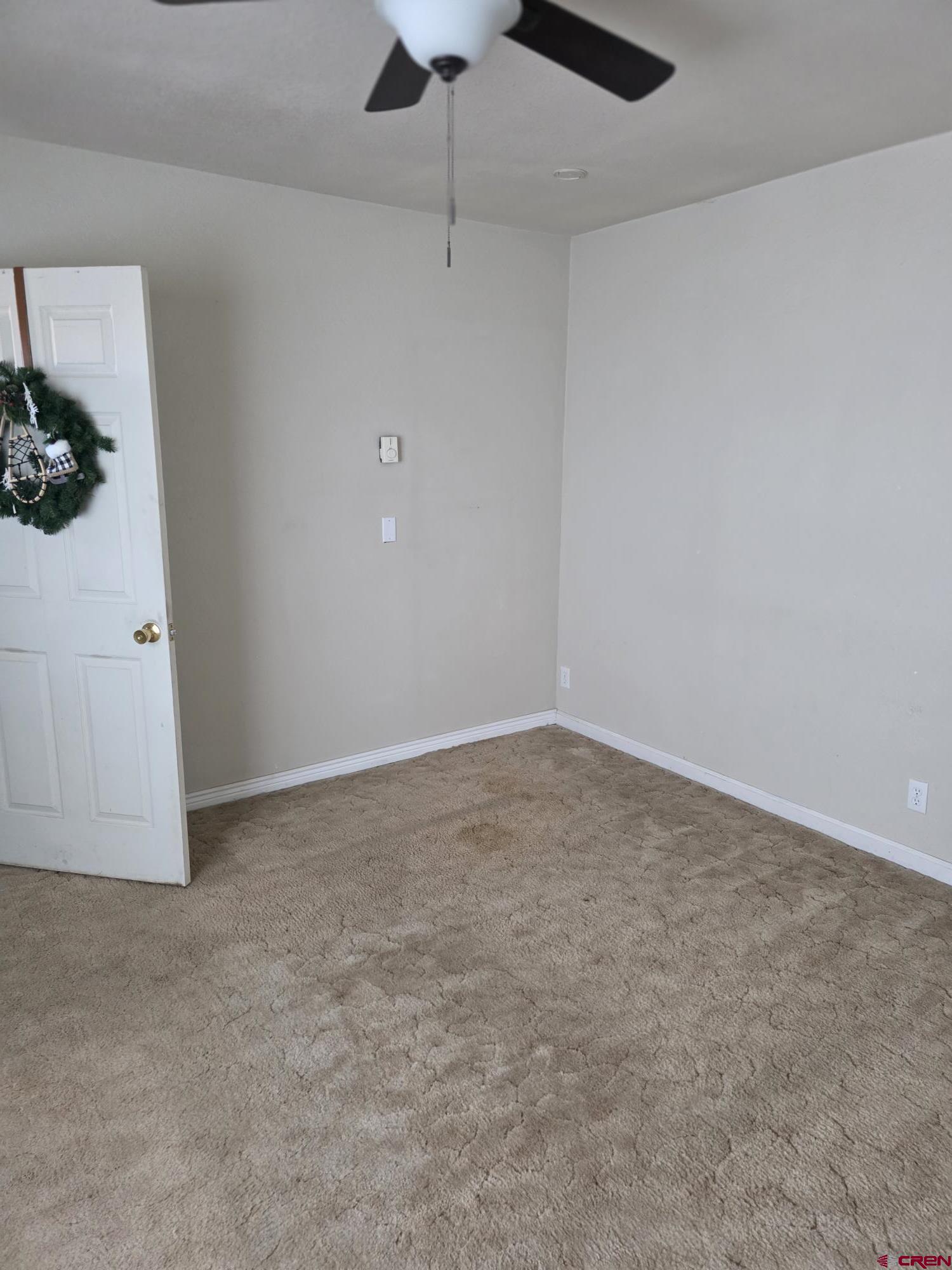 62500 Lasalle Road Montrose, CO 81403 - Photo 15 of 15 an empty room with a chandelier fan and wooden floor