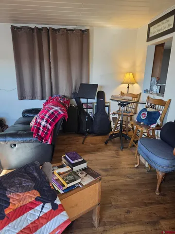 a kitchen with a sink cabinets and wooden floor