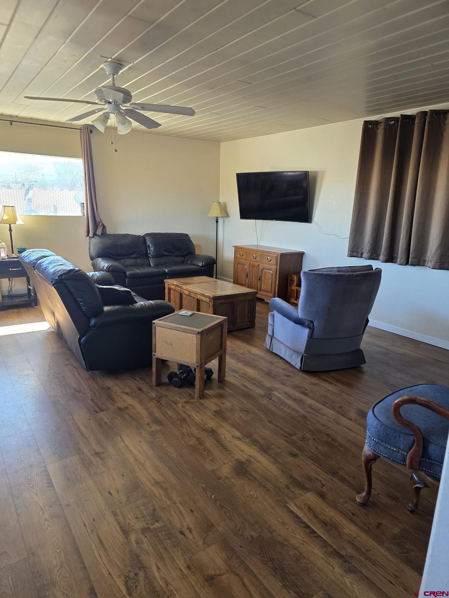 62500 Lasalle Road Montrose, CO 81403 - Photo 9 of 15 a living room with furniture and a flat screen tv