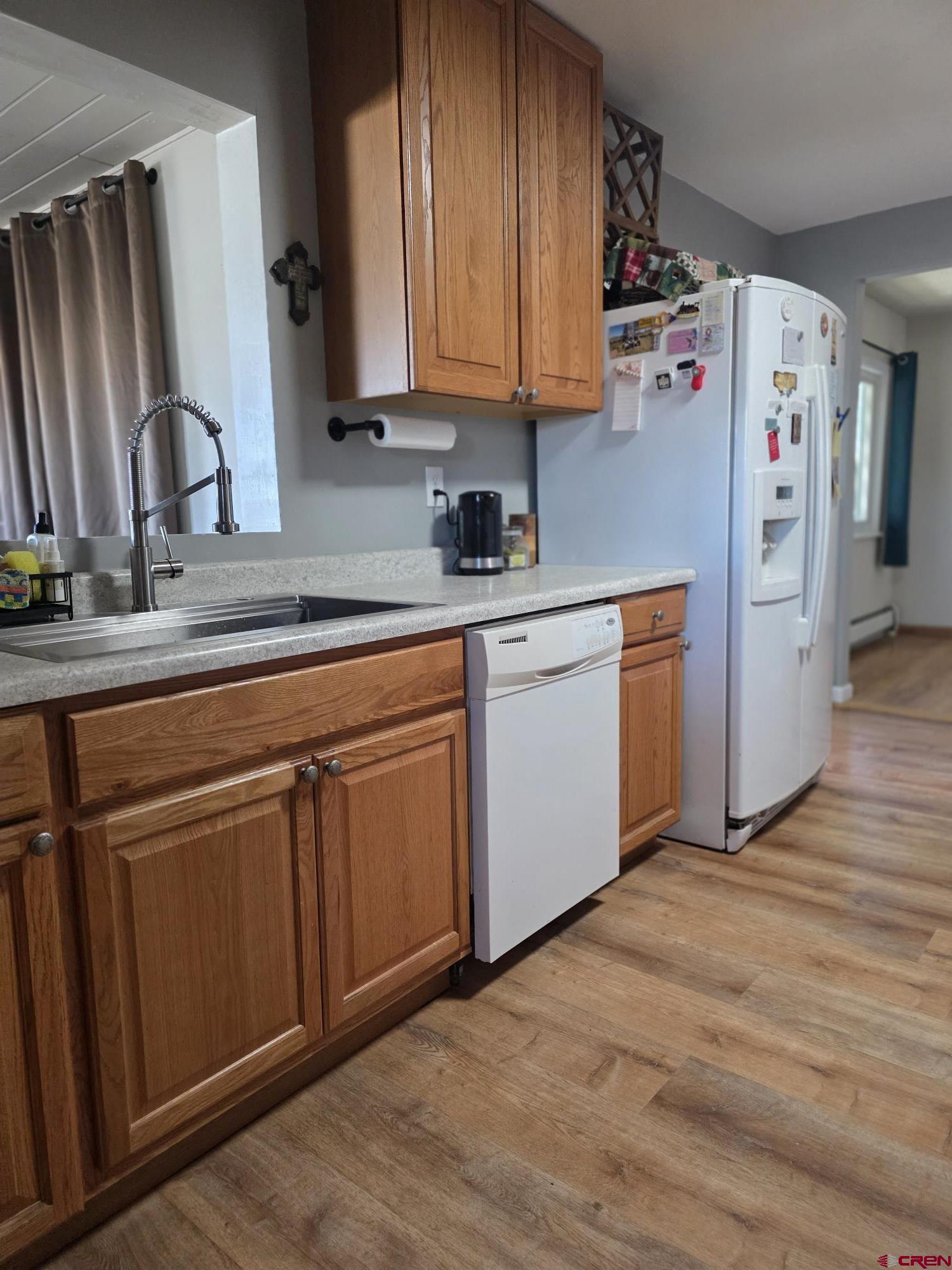 62500 Lasalle Road Montrose, CO 81403 - Photo 10 of 15 a kitchen with stainless steel appliances granite countertop a sink a refrigerator and wooden cabinets