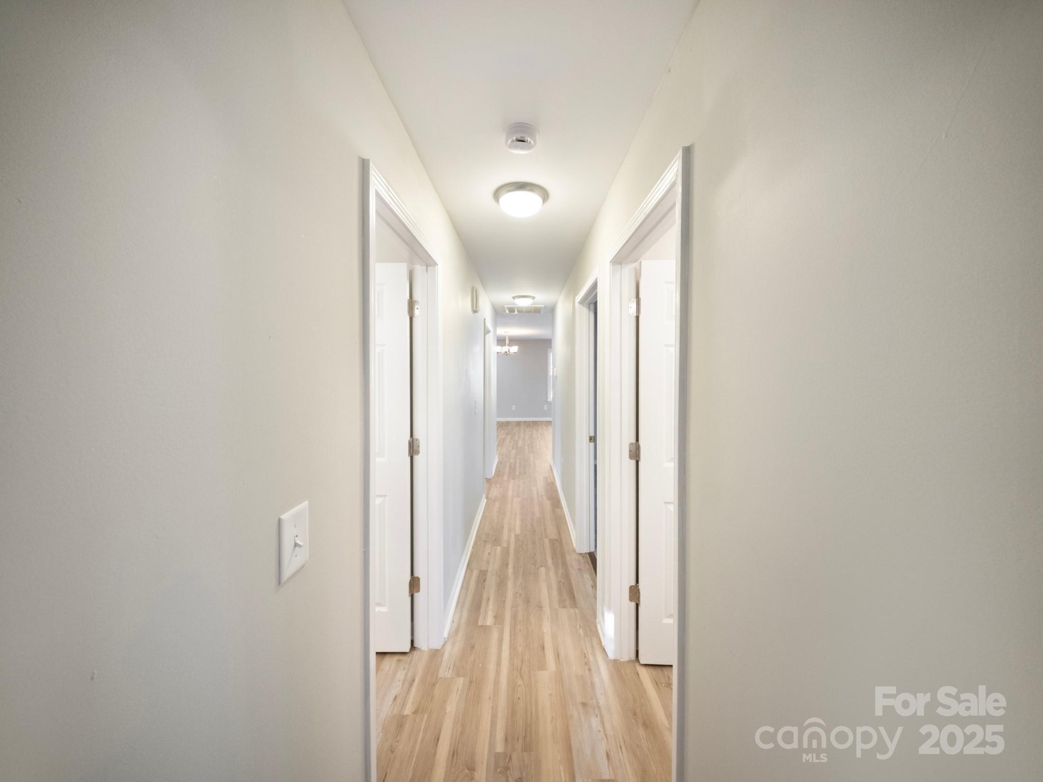 552 Locust Street Rock Hill, SC 29730 - Photo 22 of 24 a view of a hallway with wooden floor and a bathroom