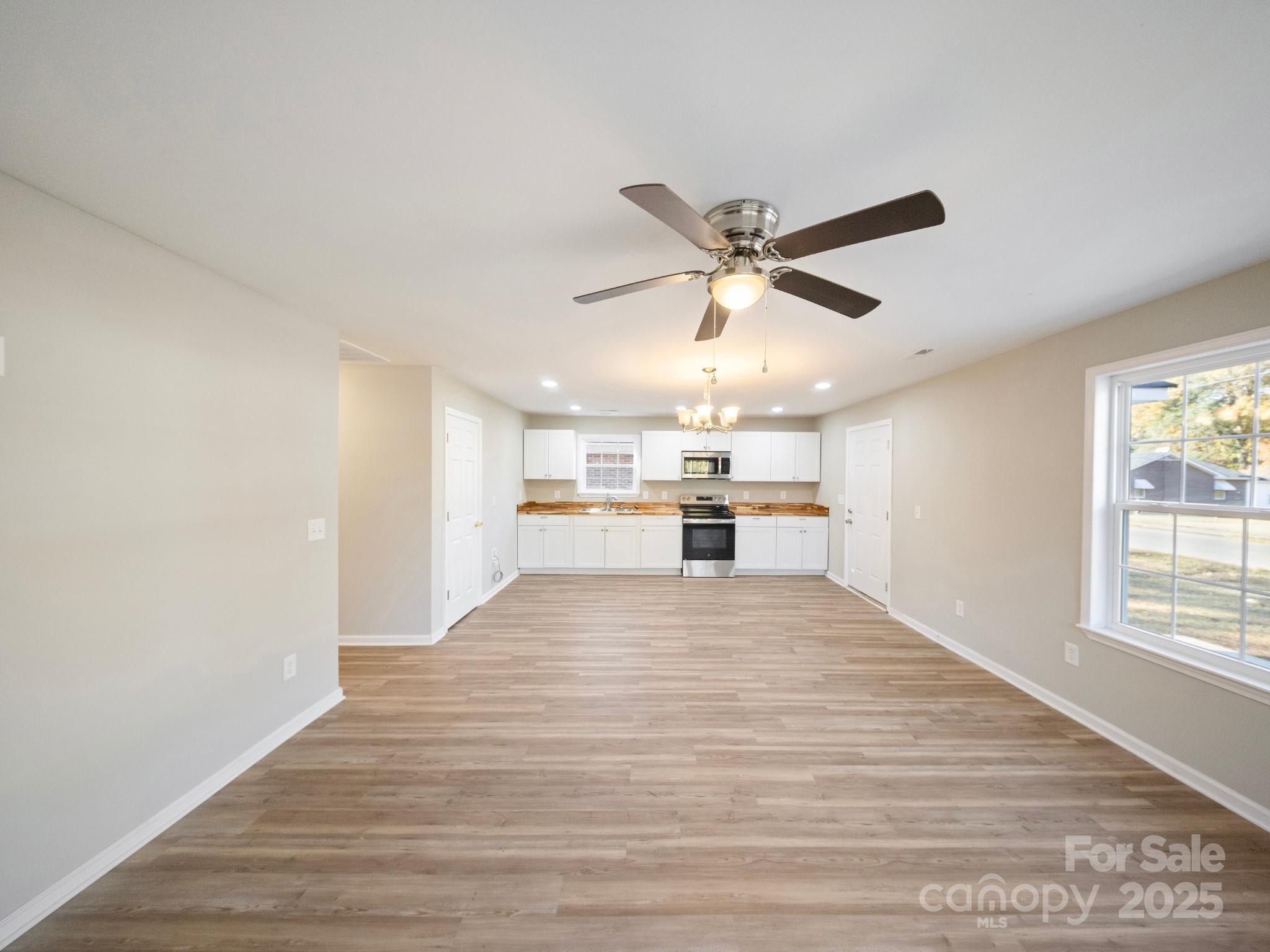 552 Locust Street Rock Hill, SC 29730 - Photo 6 of 24 a view of a kitchen with a sink dishwasher a refrigerator with wooden floor and a window