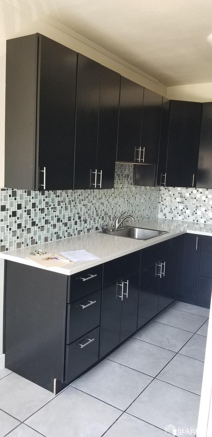 1945 26th Avenue Oakland, CA 94601 - Photo 3 of 5 a bathroom with a sink and a large mirror