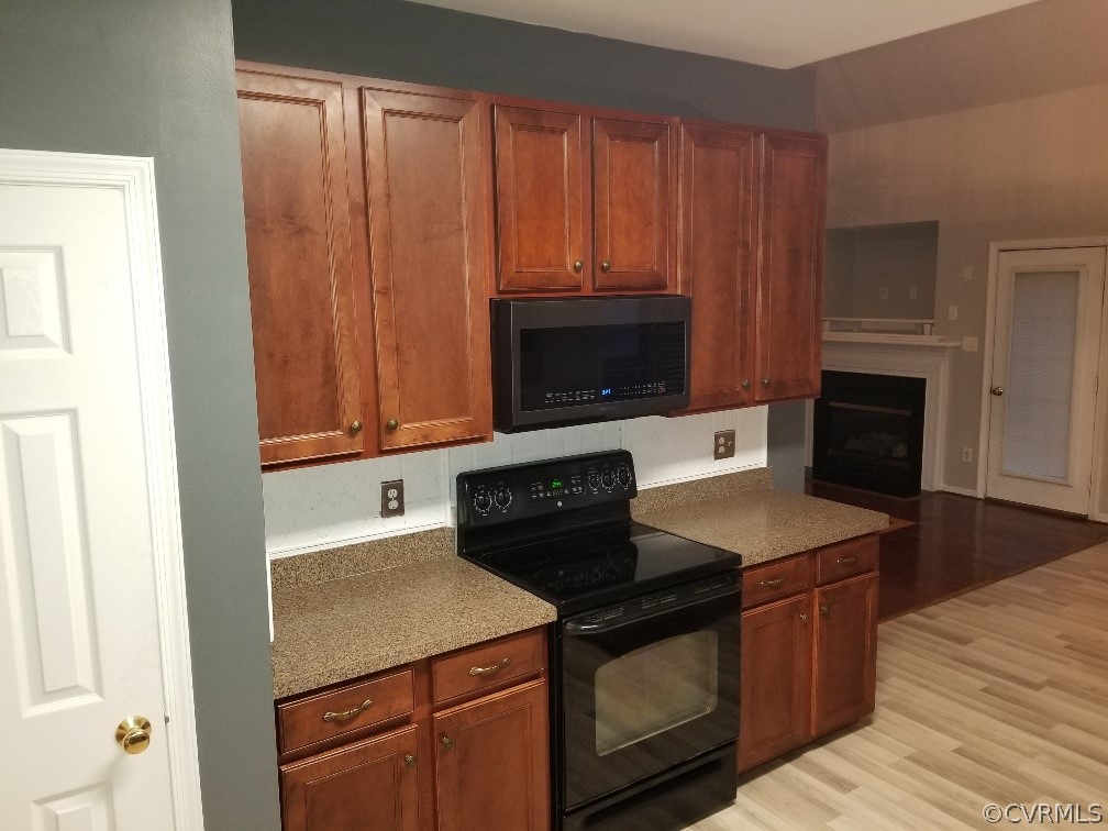 3051 Kinvan Road Henrico, VA 23231 - Photo 11 of 38 a kitchen with granite countertop a stove a microwave a sink and cabinets