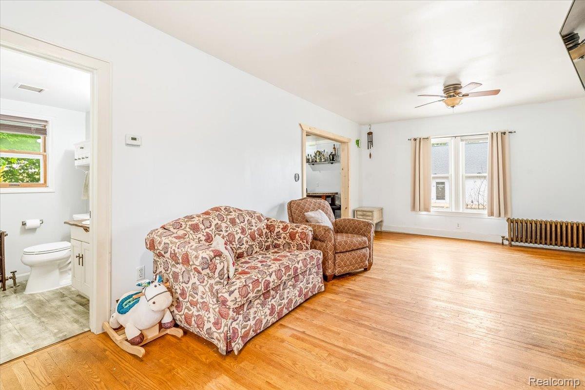 36940 Goddard Road Romulus, MI 48174 - Photo 5 of 31 Sitting room featuring light wood-style flooring, radiator heating unit, and ceiling fan