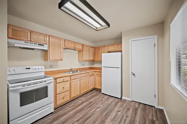 a kitchen with white cabinets and white appliances