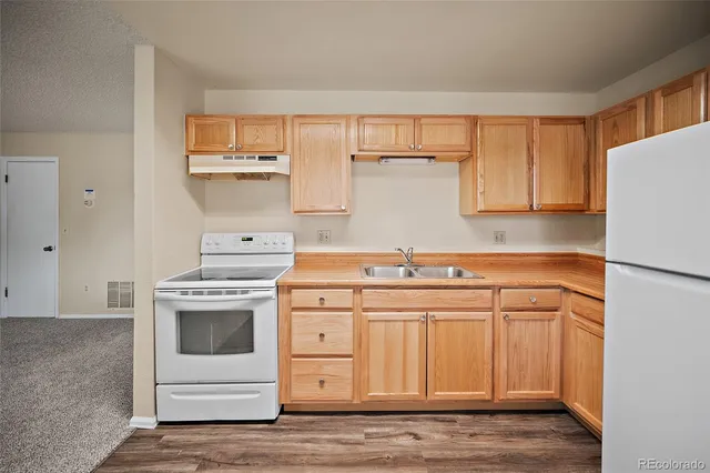 a kitchen with a stove cabinets and a sink