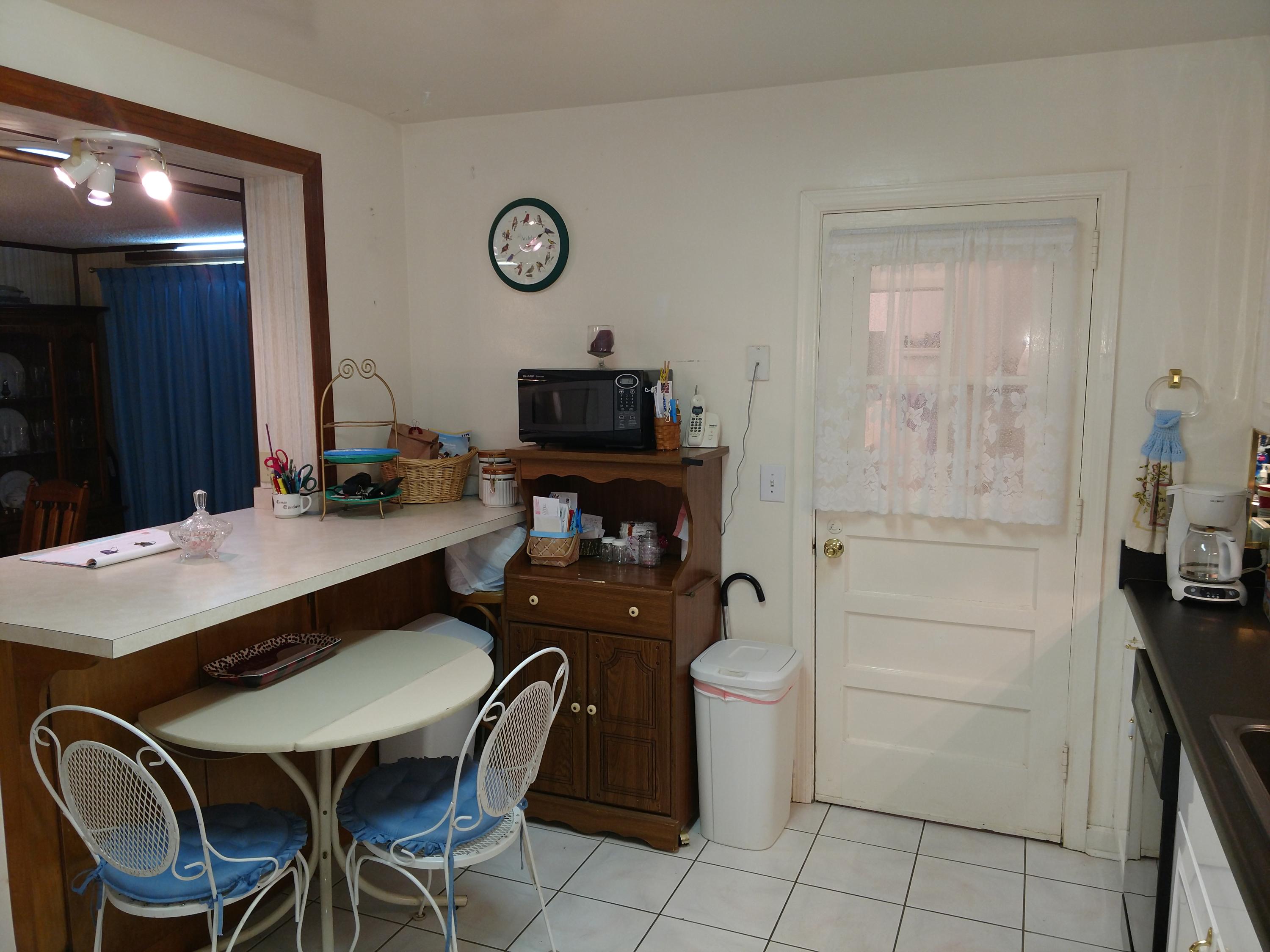 27 Choctawhatchee Road Southeast Fort Walton Beach, FL 32548 - Photo 13 of 20 a kitchen with a table chairs and a refrigerator