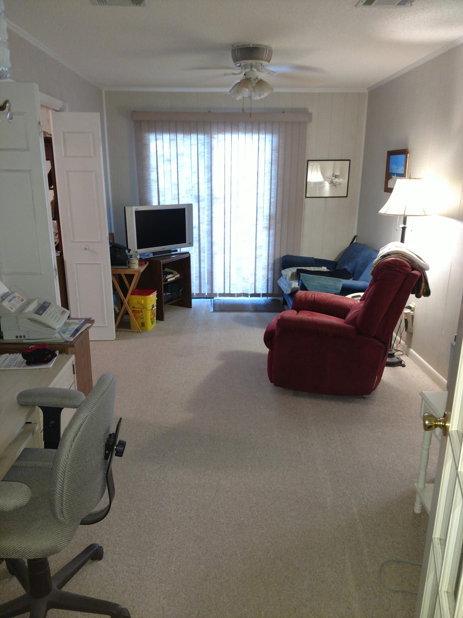 27 Choctawhatchee Road Southeast Fort Walton Beach, FL 32548 - Photo 16 of 20 a living room with furniture a flat screen tv and a window