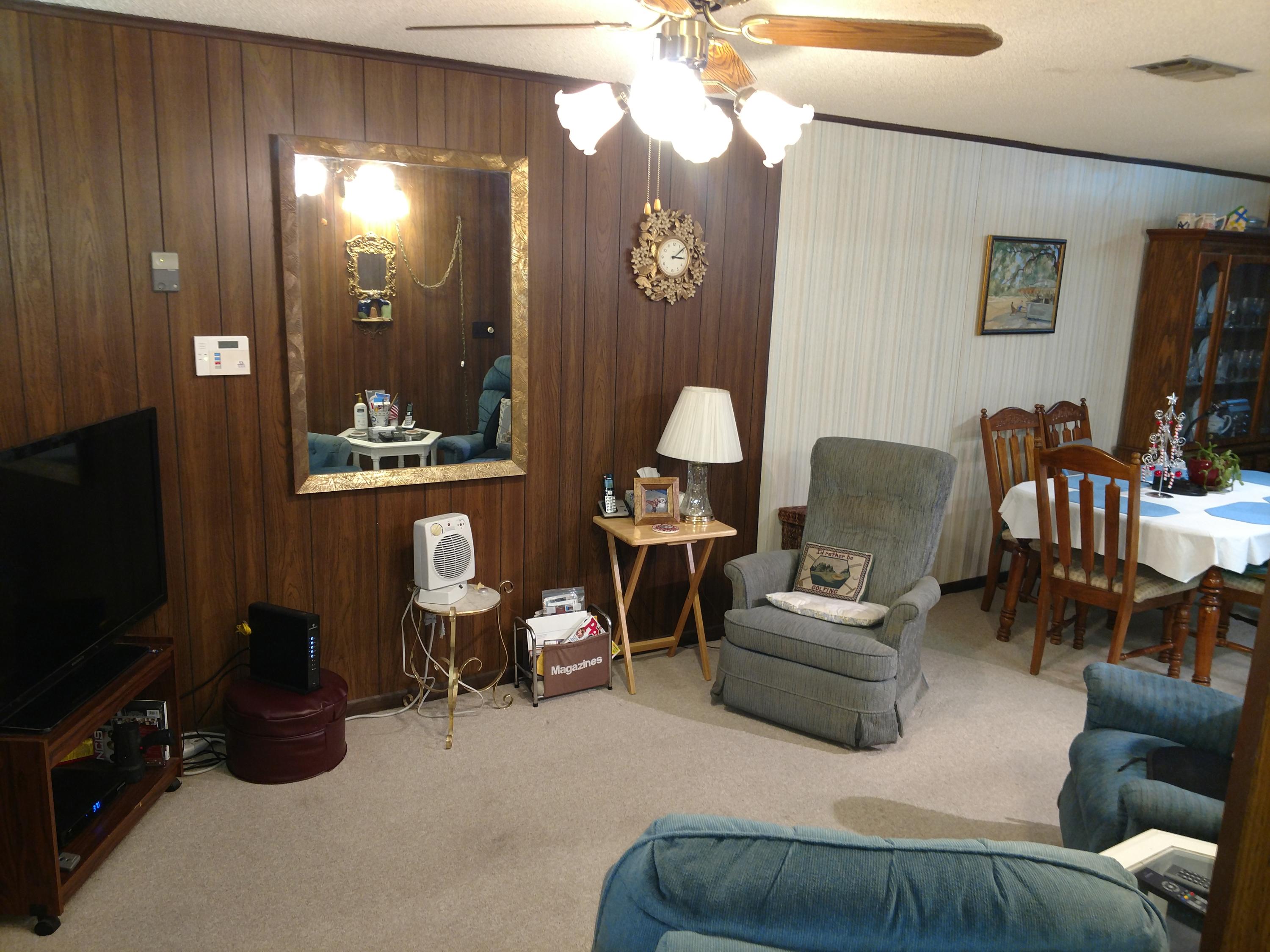 27 Choctawhatchee Road Southeast Fort Walton Beach, FL 32548 - Photo 8 of 20 a living room with furniture a flat screen tv and gym equipment