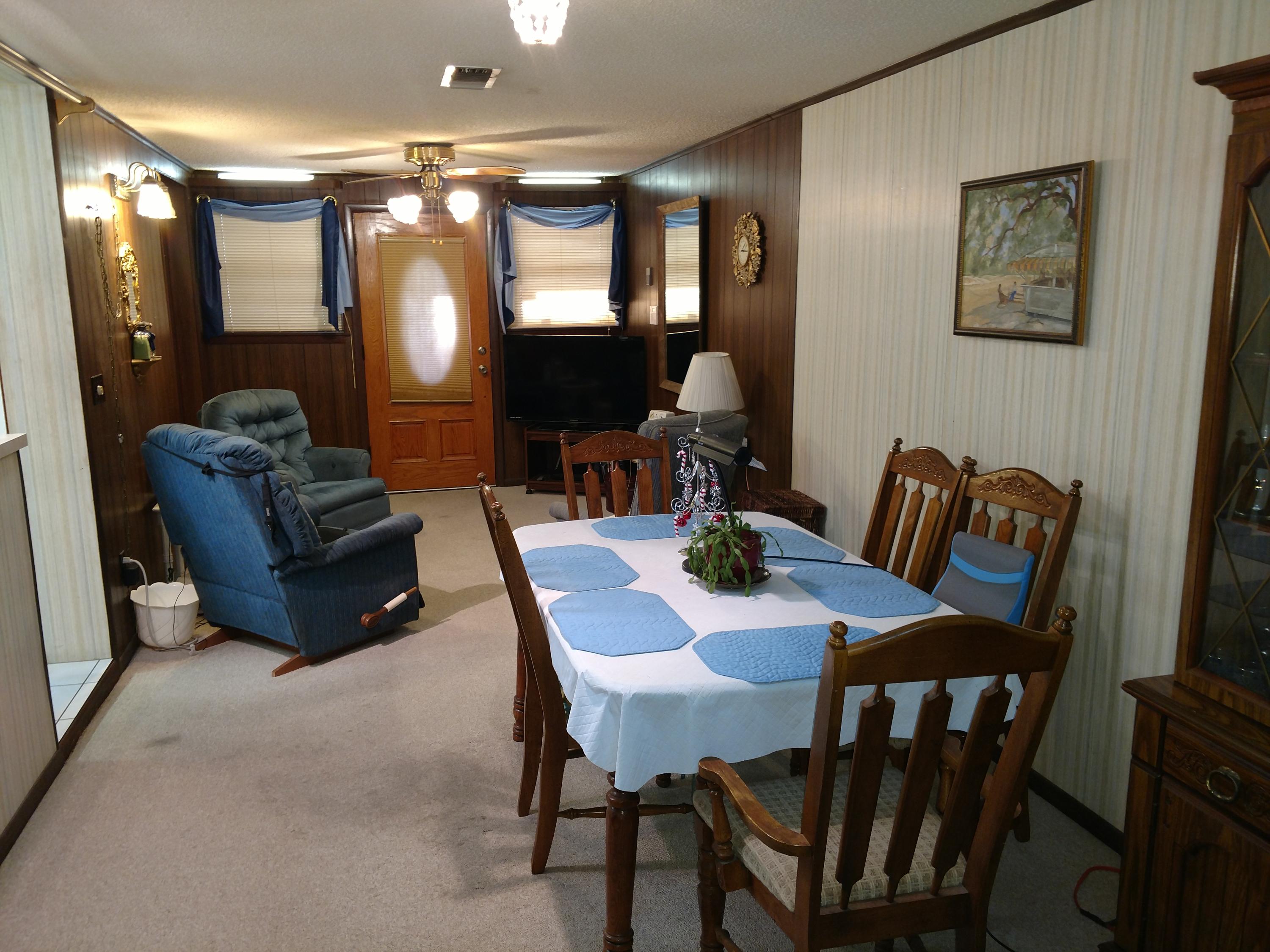 27 Choctawhatchee Road Southeast Fort Walton Beach, FL 32548 - Photo 9 of 20 a view of a dining room with furniture and a large mirror