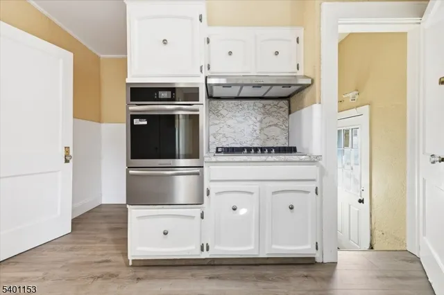 a kitchen with stainless steel appliances granite countertop a stove and a refrigerator