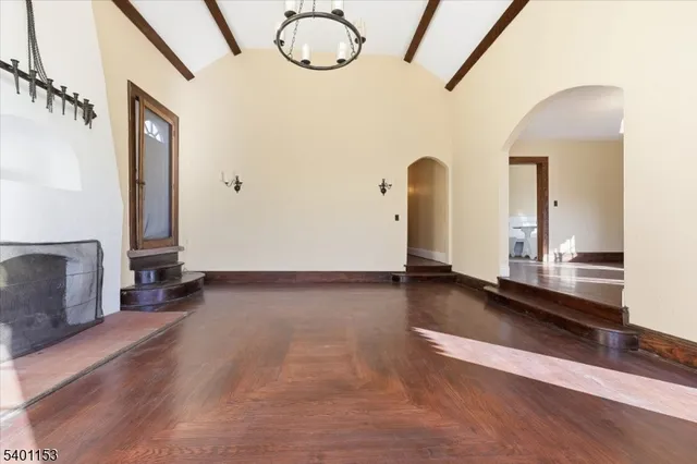 a view of a room with wooden floor and furniture