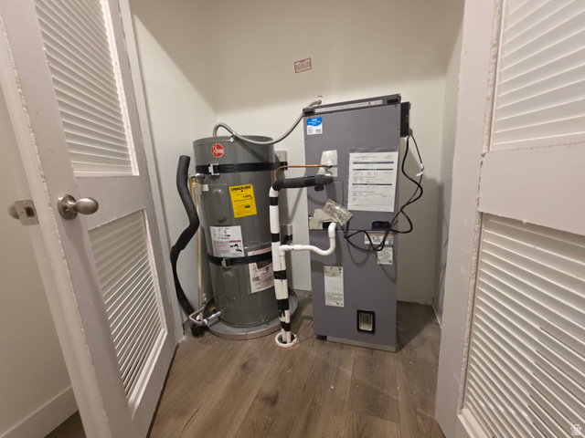 4640 West 5500 N Road Delta, UT 84624 - Photo 20 of 21 Utility closet featuring water heater and air handler unit, hard surface flooring, and louvered bifold doors
