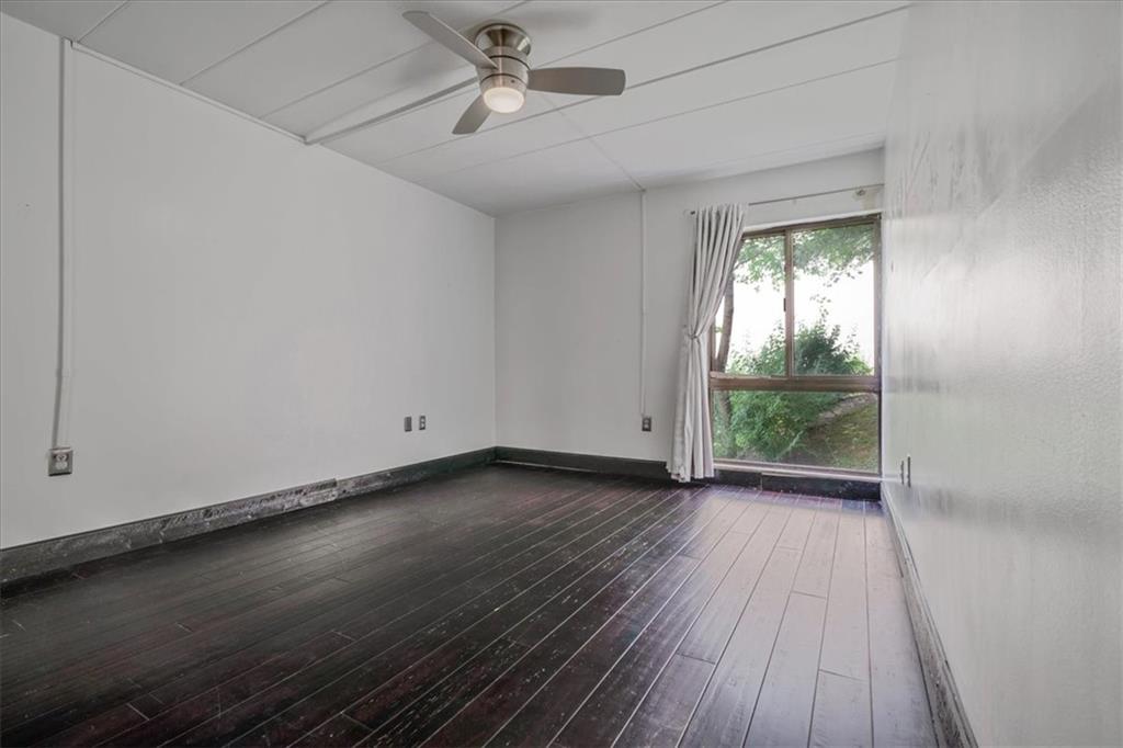 2034 Swallow Hill Road, Unit 328 Pittsburgh, PA 15220 - Photo 11 of 19 an empty room with wooden floor fan and windows