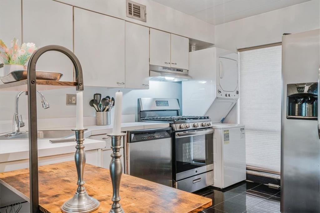 2034 Swallow Hill Road, Unit 328 Pittsburgh, PA 15220 - Photo 2 of 19 a kitchen with stainless steel appliances granite countertop a stove top oven a sink a refrigerator and white cabinets